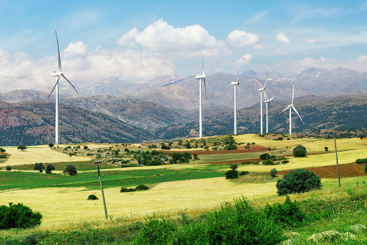 turkey-wind-farm-turbines-green-foreground-grey-mountains-background-blue-sky-clouds.jpg