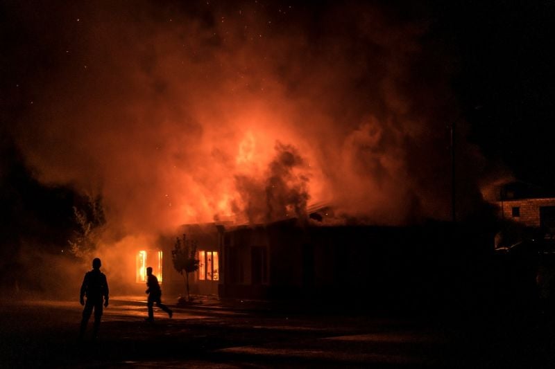 A fire burns in a hardware store after a rocket attack in Stepanakert, Nagorno-Karabakh, on Oct. 3.
