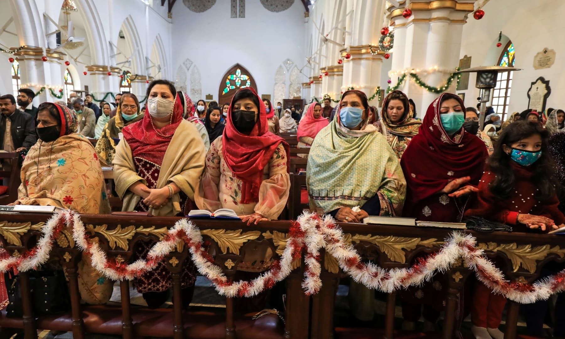 People wearing protective masks attend a Christmas service at St. John's Cathedral in Peshawar, December 25, 2020. — Reuters