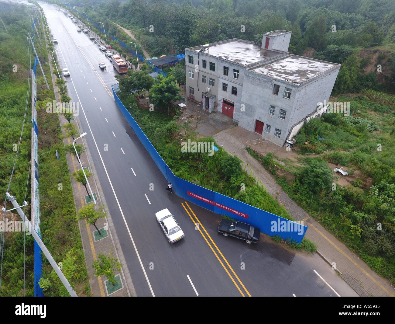 aerial-view-of-the-nail-house-chopping-off-a-road-as-house-owners-refuse-to-move-due-to-compensation-issues-in-zhengzhou-city-central-chinas-henan-p-W65935.jpg
