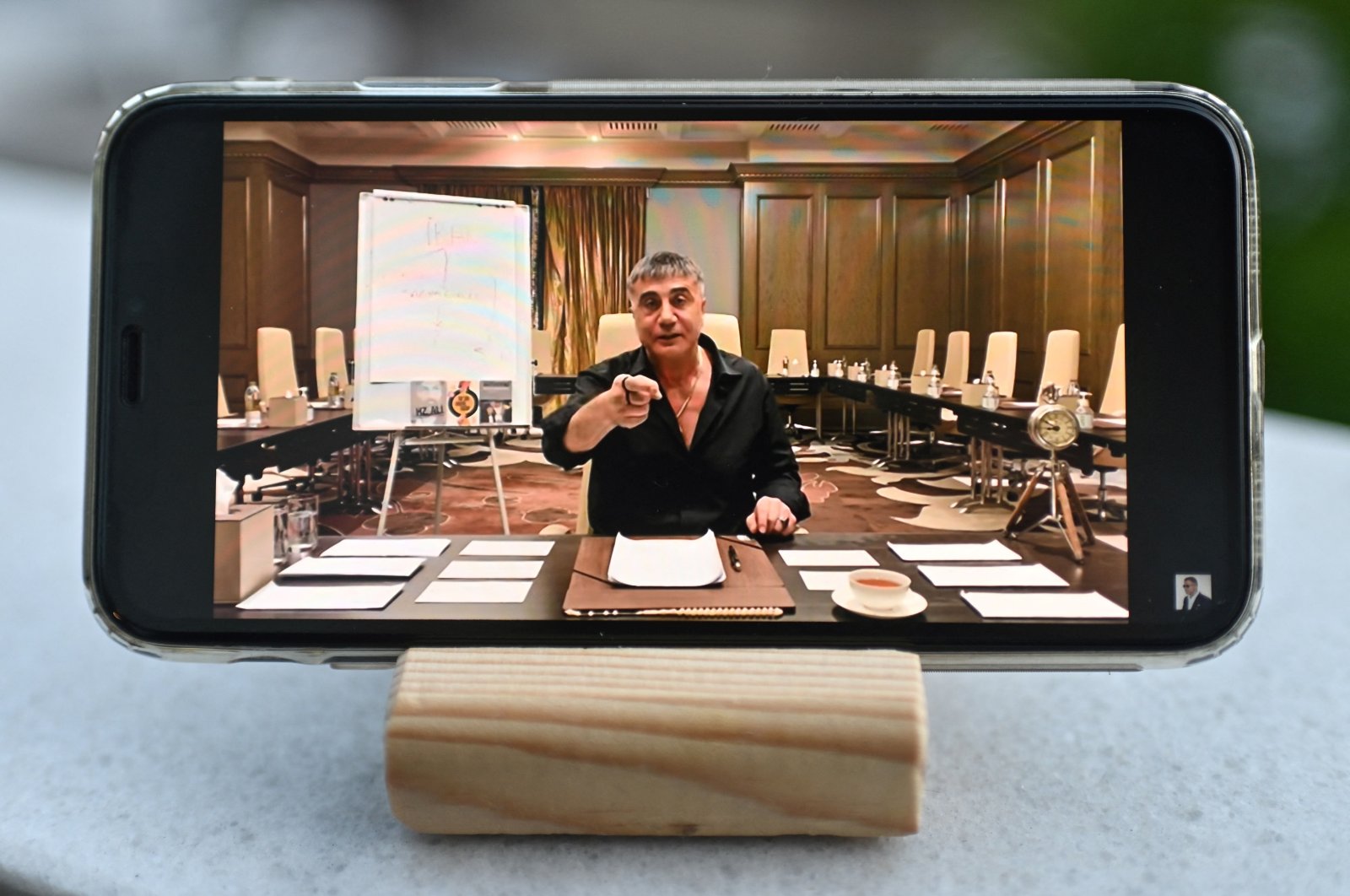 Sedat Peker talks in a video displayed on a mobile phone, in a photograph taken in Istanbul, Turkey, May 26, 2021. (AFP PHOTO)