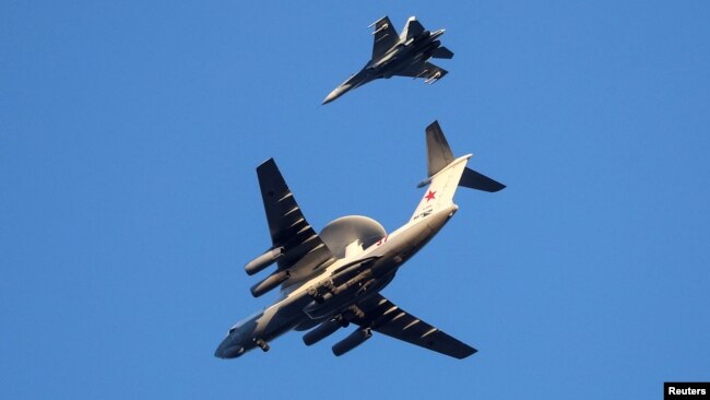 FILE - Russian Air Force Beriev A-50 early warning aircraft and Sukhoi Su-27 jet fighter fly in Kaliningrad, Russia, Apr. 25, 2020.