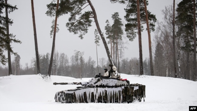 FILE - British soldiers take part in a major drill as part of the EFP NATO operation at the Tapa Estonian army camp near Rakvere, on Feb. 6, 2022.