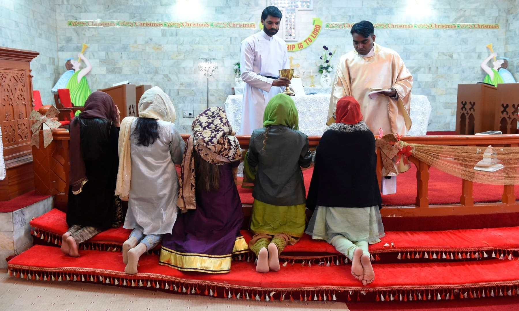 Christian devotees attend a prayer service on Christmas Day at the Methodist church on Christmas Day, in Quetta. — AFP