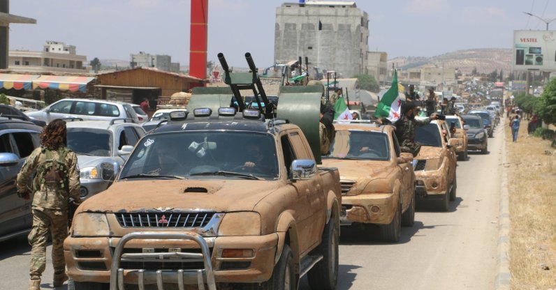 Turkey-backed opposition forces are pictured in the border town of Azaz as they head toward an area facing the town of Tal Rifaat, northern Syria, June 10, 2022. (Photo by Uğur Yıldırım)