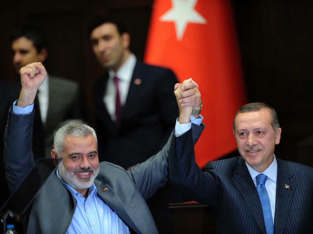 turkey-s-prime-minister-recep-tayyip-erdogan-and-hamas-gaza-leader-ismail-haniyeh-greet-members-of-parliament-from-erdogan-s-ruling-ak-party-in-ankara.jpeg