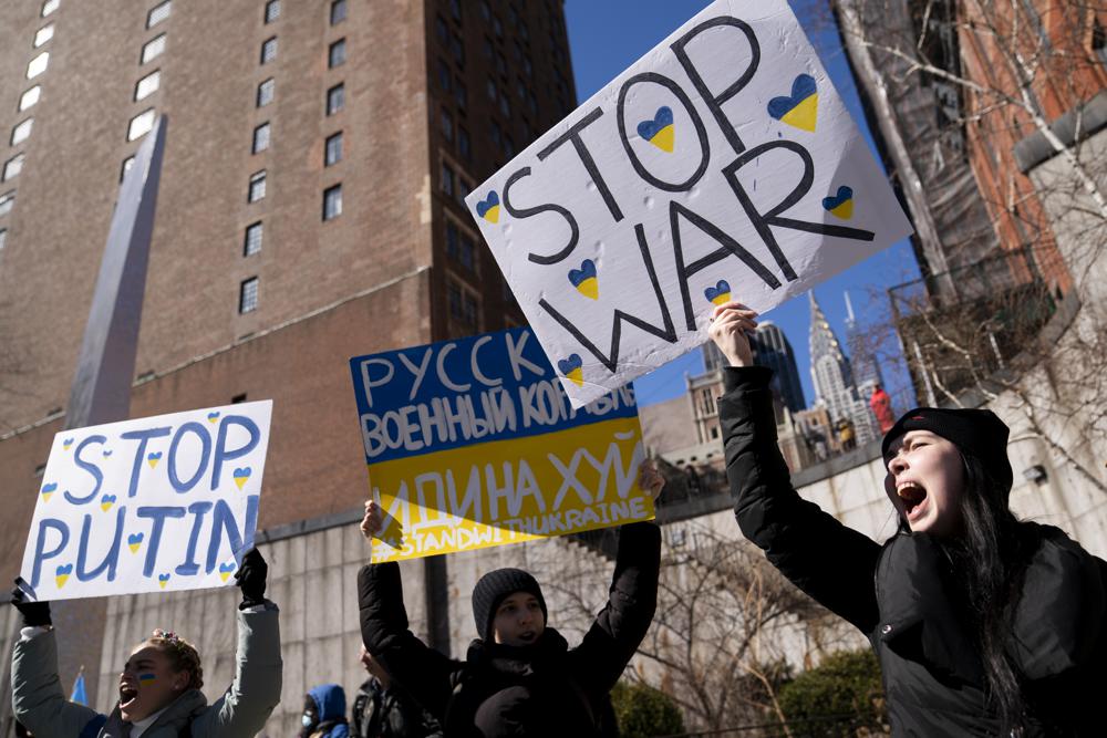 Demonstrators supporting Ukraine gather outside the United Nations during an emergency meeting of the U.N. General Assembly, Monday, Feb. 28, 2022, in New York. The U.N.'s two major bodies, the 193-nation General Assembly and the more powerful 15-member Security Council, are holding separate meetings Monday on Russia's invasion of Ukraine. (AP Photo/John Minchillo)