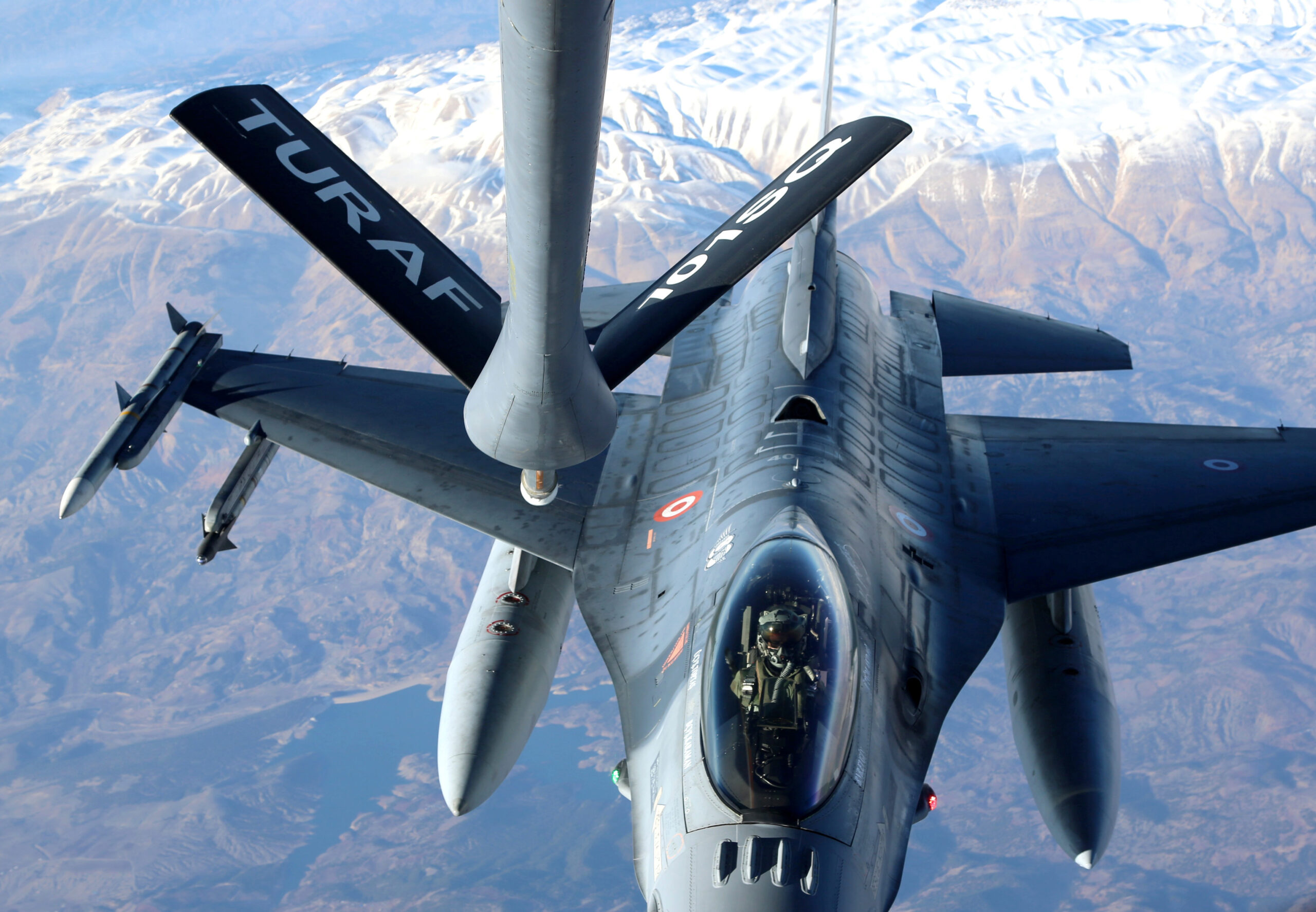 A Turkish Air Force F-16 prepares to hook up to a tanker for aerial refueling over Adana, Turkey, in January 2014. <em>Photo by Veli Gurgah/Anadolu Agency/Getty Images</em>