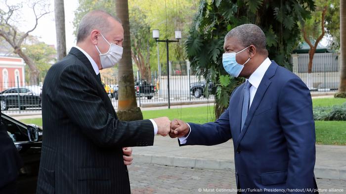 Turkish President Recep Tayyip Erdogan (l) welcomed by Angolan President Joao Manuel Goncalves Lourenco with a fist bump