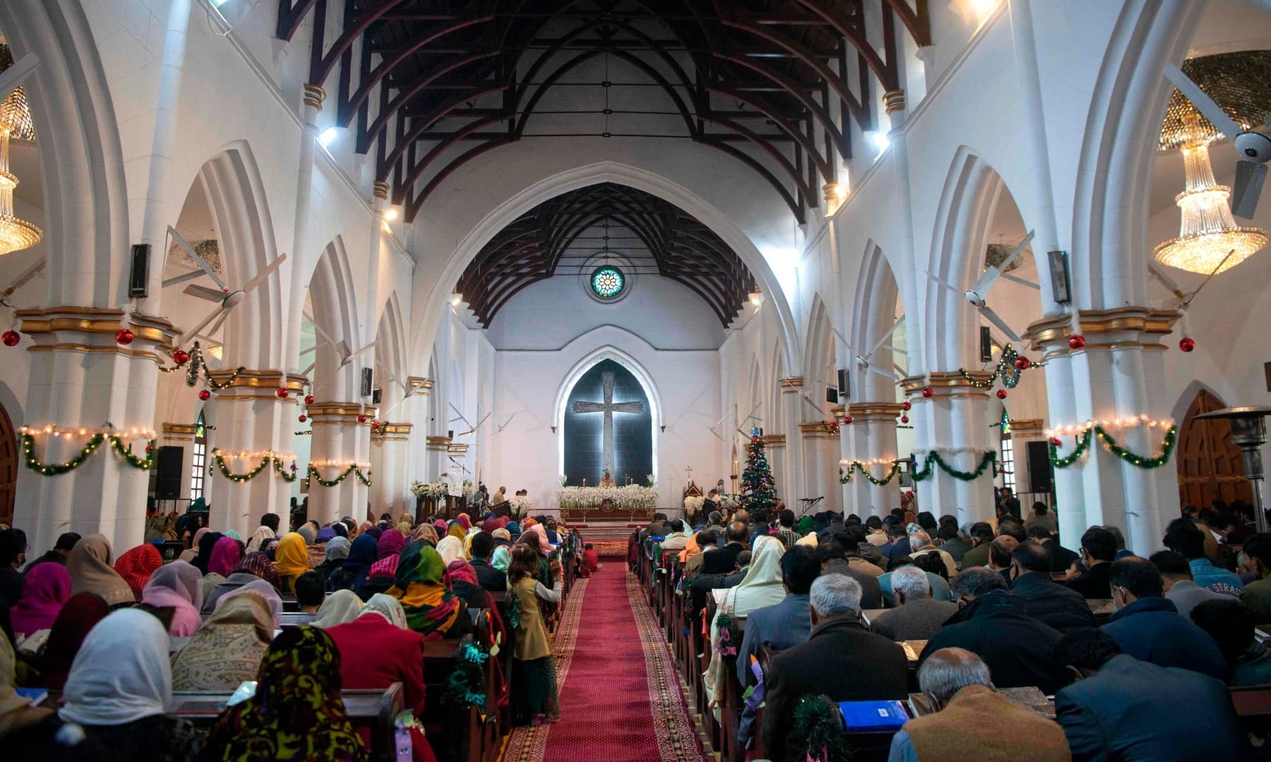 Christian devotees attend a prayer service on Christmas Day at St. John's Cathedral in Peshawar. — AFP