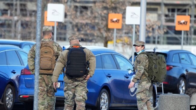 FILE - US Army officers after arrival at the Rzeszow-Jasionka airport in southeastern Poland, Feb. 5, 2022, coming from Wiesbaden, Germany where a U.S. Army administration garrison is based.