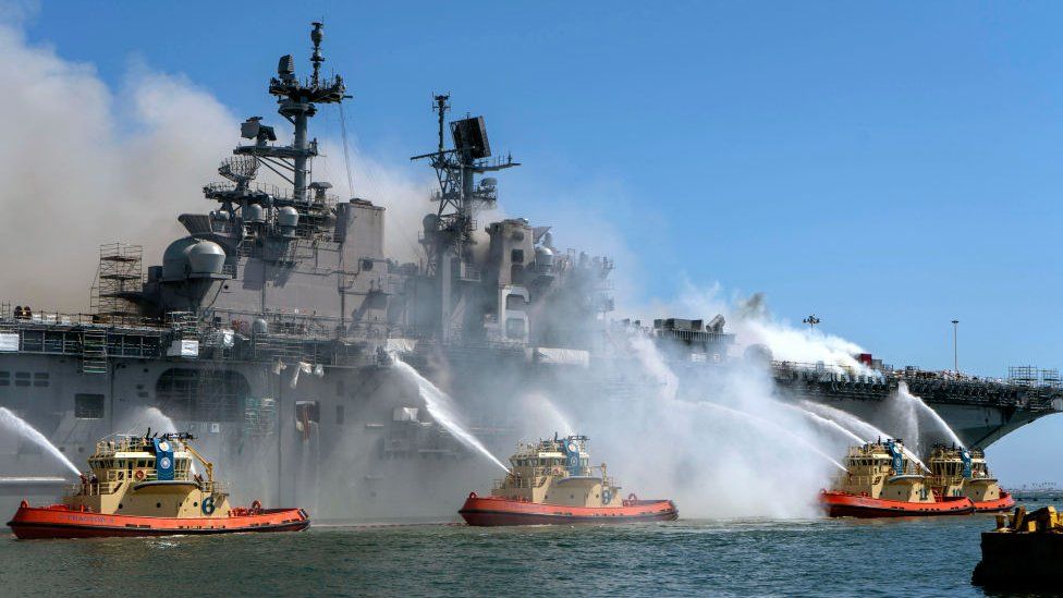 File photo showing firefighters near ship
