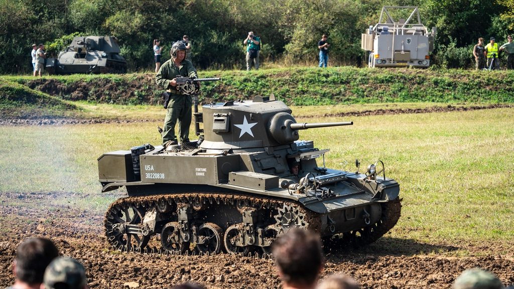 An M3 Stuart light tank drives during a historical reenactment.