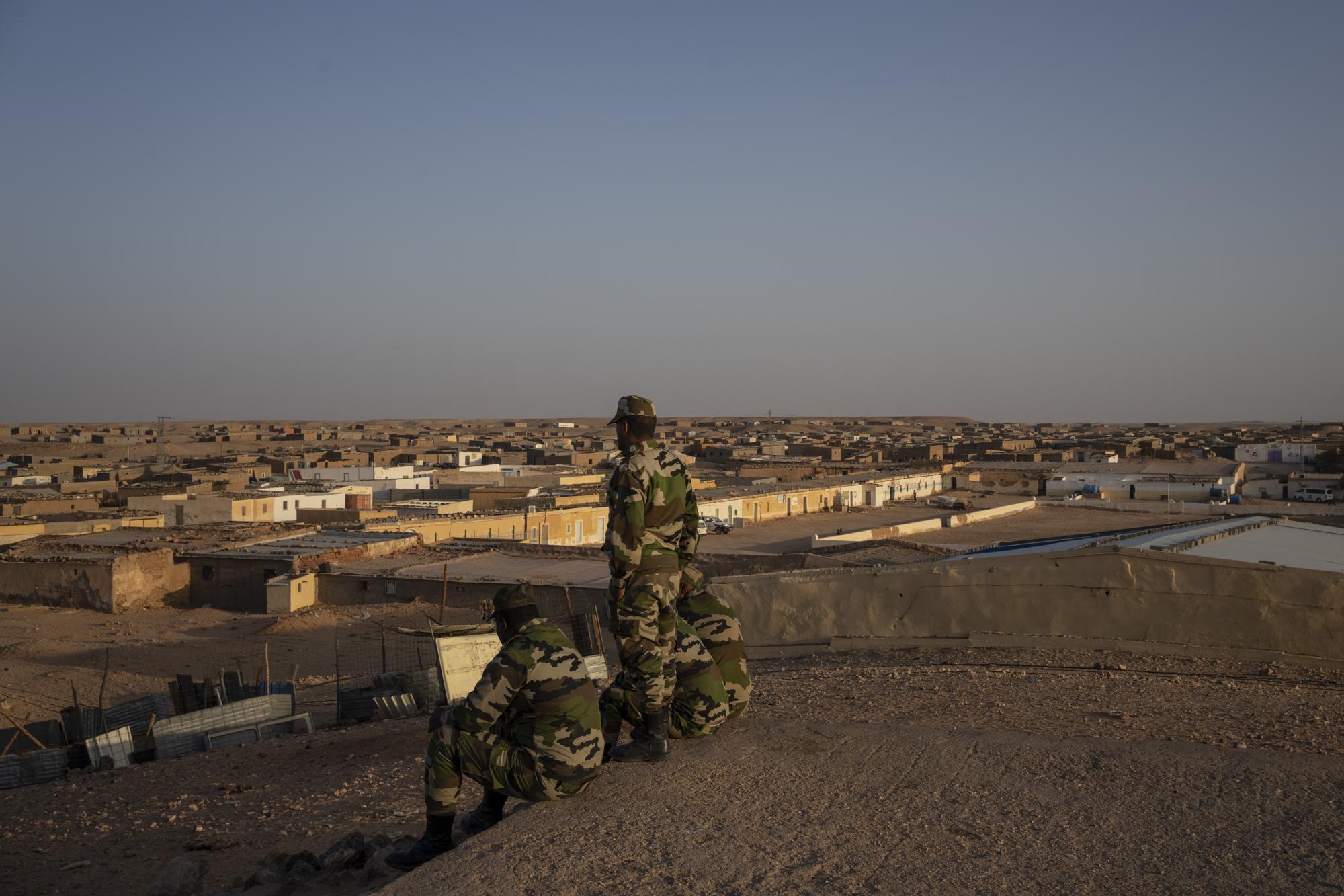 Polisario soldiers sit on a cliff in the Boujdour refugee camp, Algeria, Friday, Oct. 15, 2021. (AP Photo/Bernat Armangue)