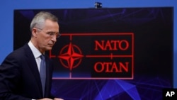 FILE - NATO Secretary General Jens Stoltenberg leaves after speaking at a media conference at NATO headquarters, in Brussels, Belgium, Jan. 12, 2022.