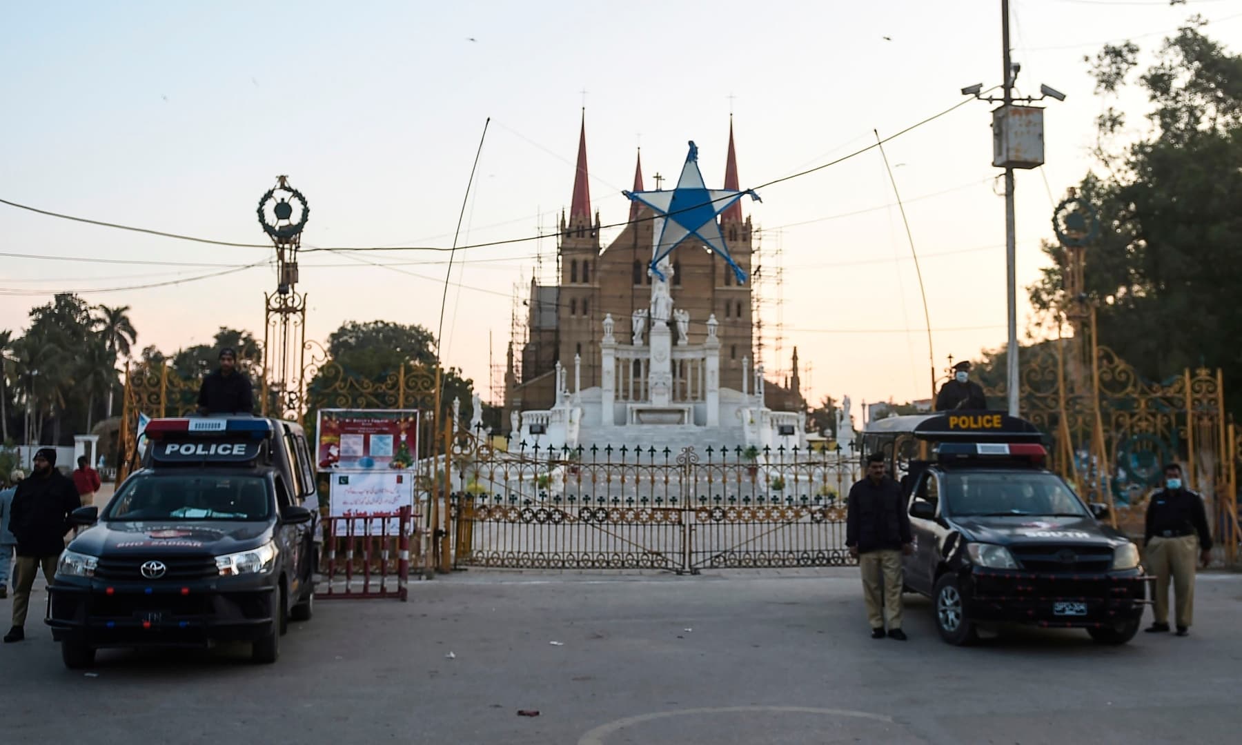 Policemen stand guard during prayers at the Saint Patrick's Cathedral on Christmas Day in Karachi on December 25. — AFP