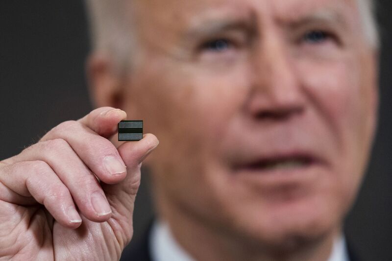 US President Joe Biden holds a semiconductor before signing an executive order at the White House in Washington, on Feb. 24, 2021.