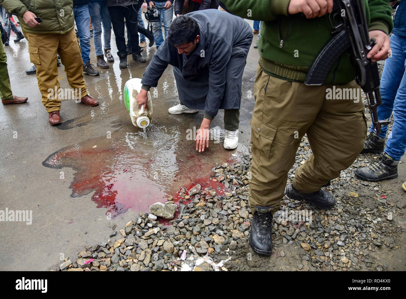january-17-2019-srinagar-jammu-kashmir-india-a-kashmiri-man-seen-cleaning-the-blood-near-the-site-of-explosion-in-srinagaraccording-to-police-at-least-five-members-of-government-forces-were-injured-on-thursday-in-a-grenade-explosion-blamed-on-rebels-fighting-against-indian-rule-in-indian-controlled-kashmirs-main-city-credit-idrees-abbassopa-imageszuma-wirealamy-live-news-RD4KX0.jpg
