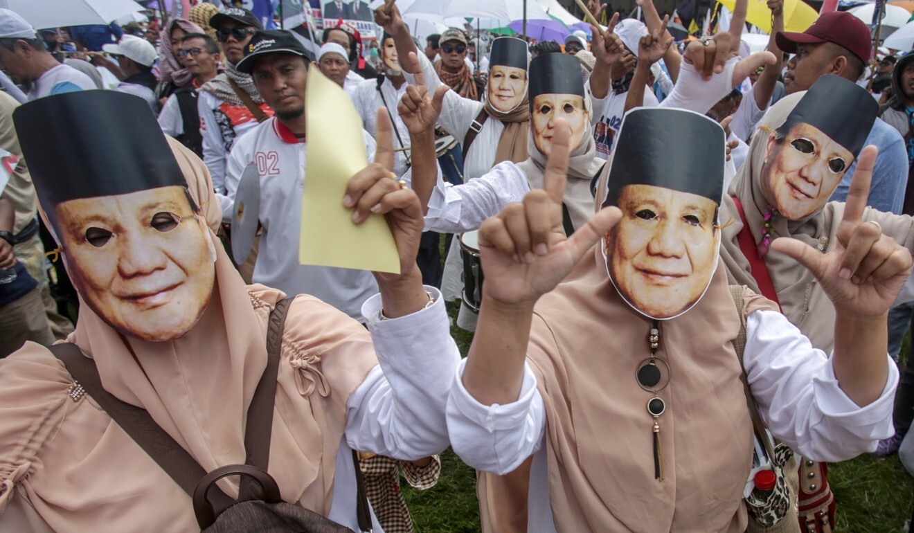 Supporters wear masks resembling Prabowo Subianto during a campaign rally before the last Indonesian general election. Photo: EPA