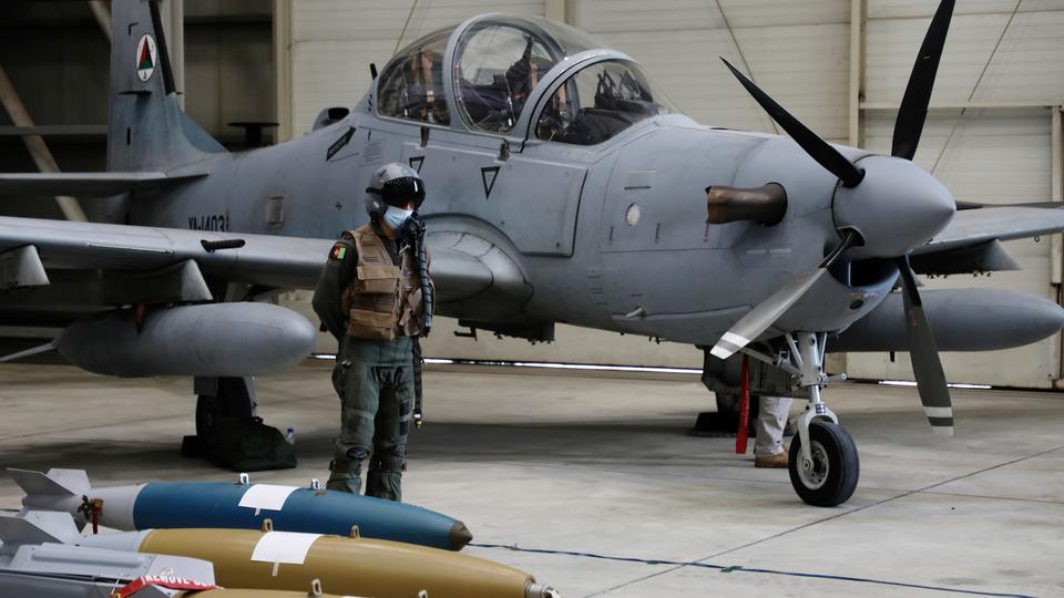 An Afghan pilot stands next to A-29 Super Tucano plane during a handover ceremony of A-29 Super Tucano planes from US to the Afghan forces, in Kabul, Afghanistan September 17, 2020.