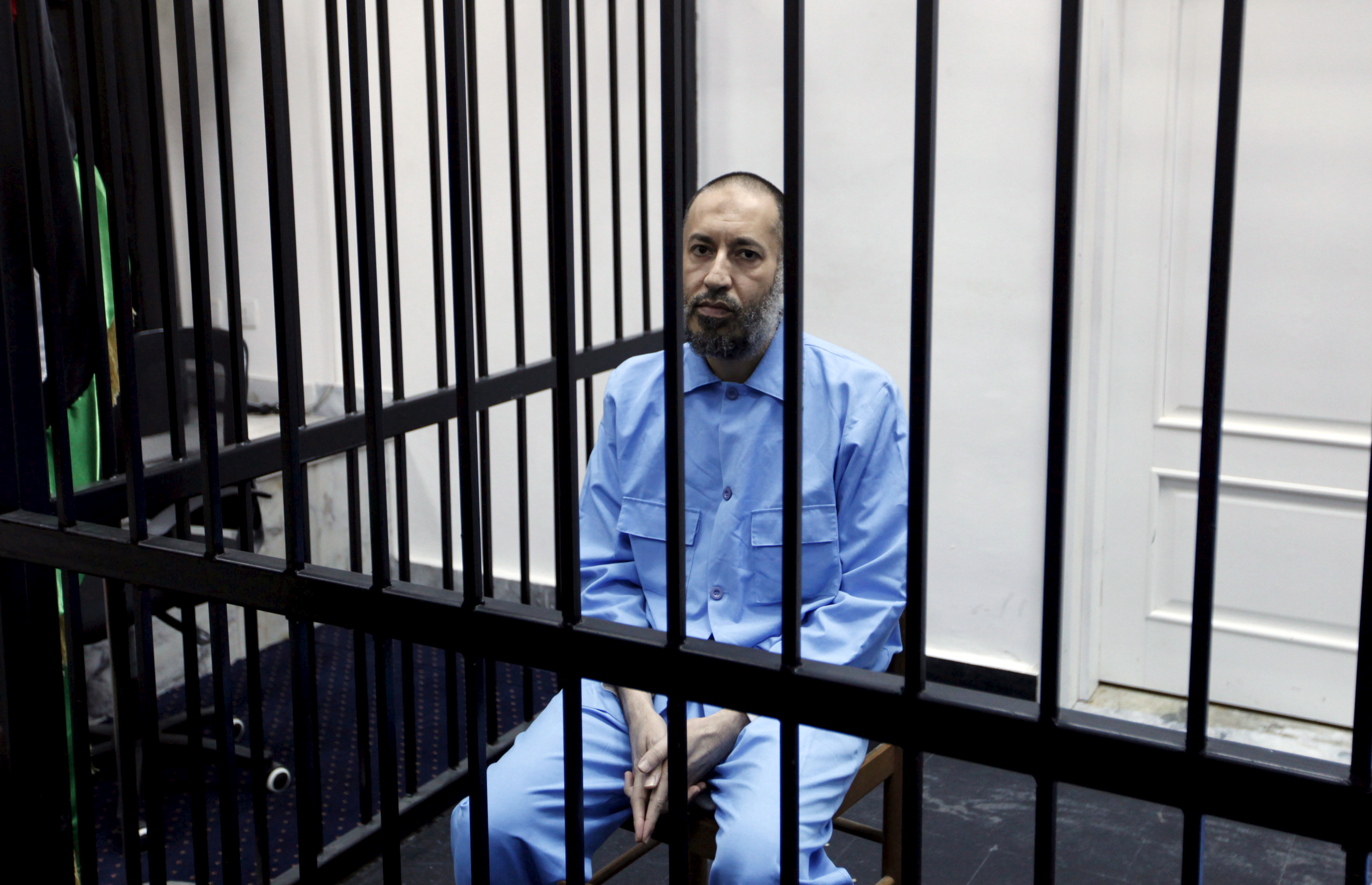 Saadi Gaddafi, son of Muammar Gaddafi, sits behind bars during a hearing at a courtroom in Tripoli, Libya February 7, 2016. REUTERS/Ismail Zitouny/File Photo