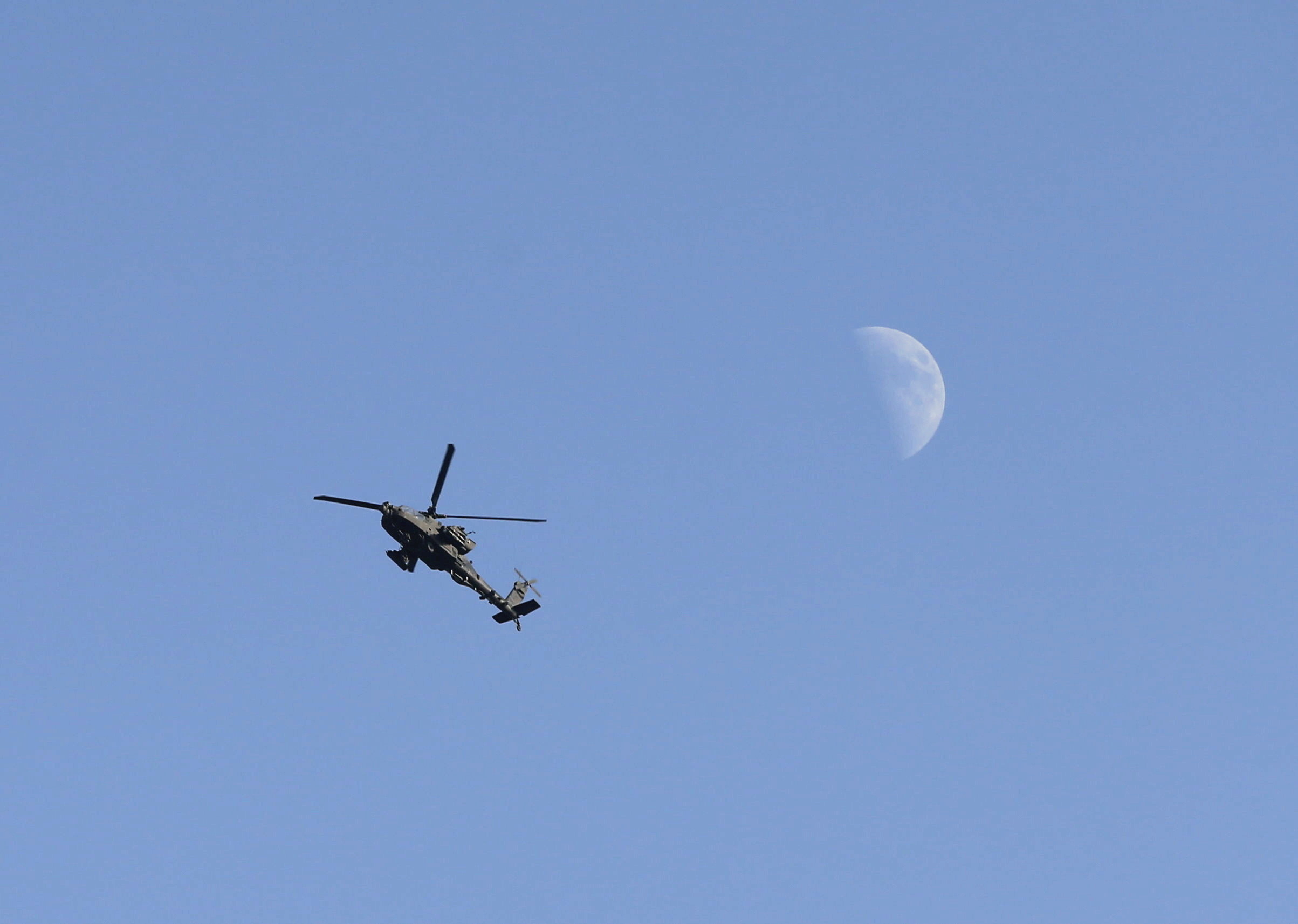 U.S. Army Apache helicopter flies over Kabul, Afghanistan August 15, 2021. REUTERS/Stringer