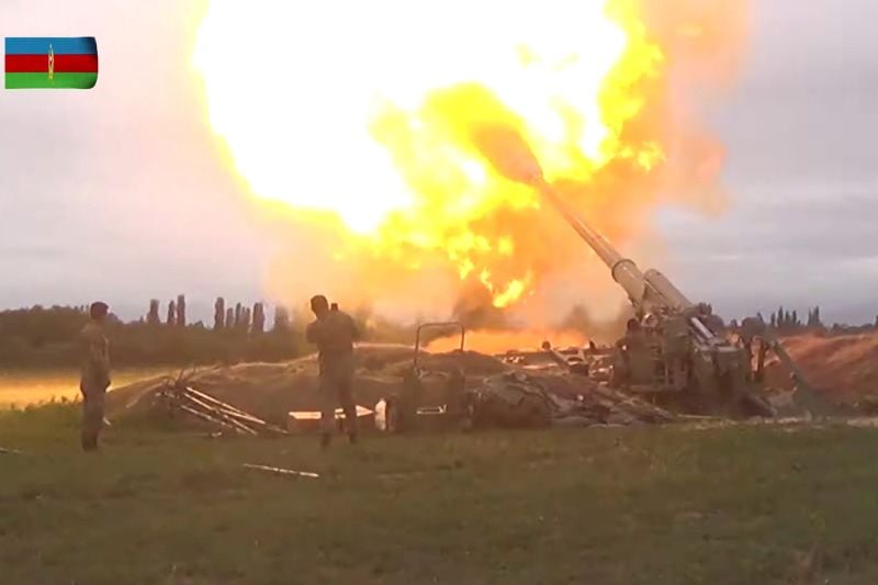 A video still shows members of Azerbaijan's armed forces firing artillery during clashes between Armenia and Azerbaijan over the territory of Nagorno-Karabakh in an unidentified location, from footage released Sept. 28.