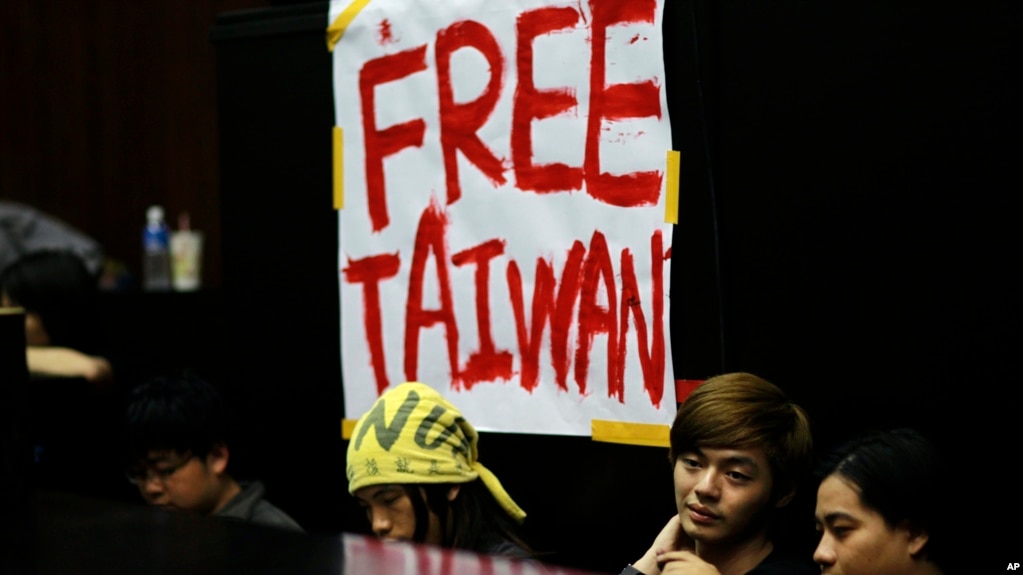 FILE - Students protesting against a China-Taiwan trade pact occupy the legislature floor, in Taipei, Taiwan, March 20, 2014.