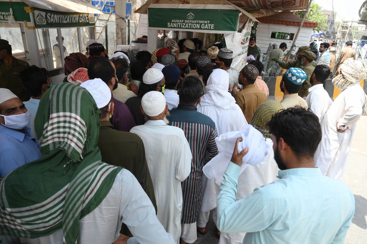 Men gather outside Data Darbar's new sanitisation gate | Arif Ali/White Star