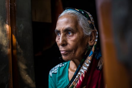An older woman stares past the camera