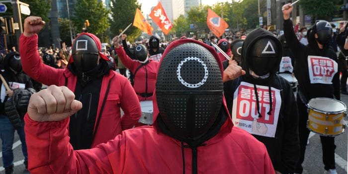 Unions workers in Seoul, South Korea, wear masks and costumes inspired by the Netflix original Korean series Squid Game.