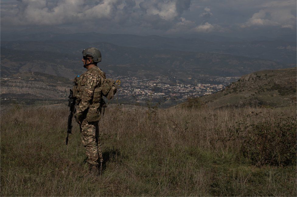 An Azerbaijani soldier stands at a retaken outpost overlooking the city of Khankendi, known as Stepanakert to Armenians, in the Nagorno-Karabakh region