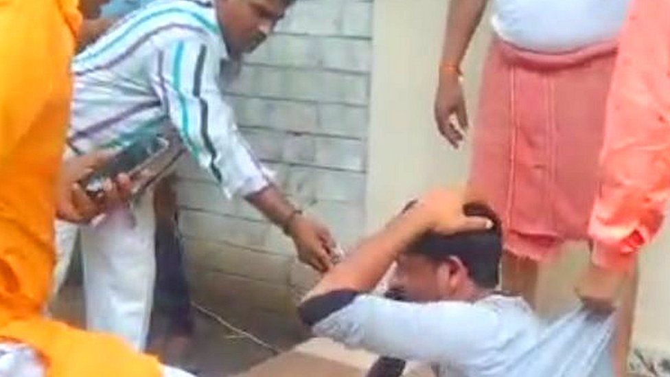 A screen grab of the viral video showing a bangle-seller being assaulted in Indore A screen grab of the viral video showing a bangle-seller being assaulted in Indore