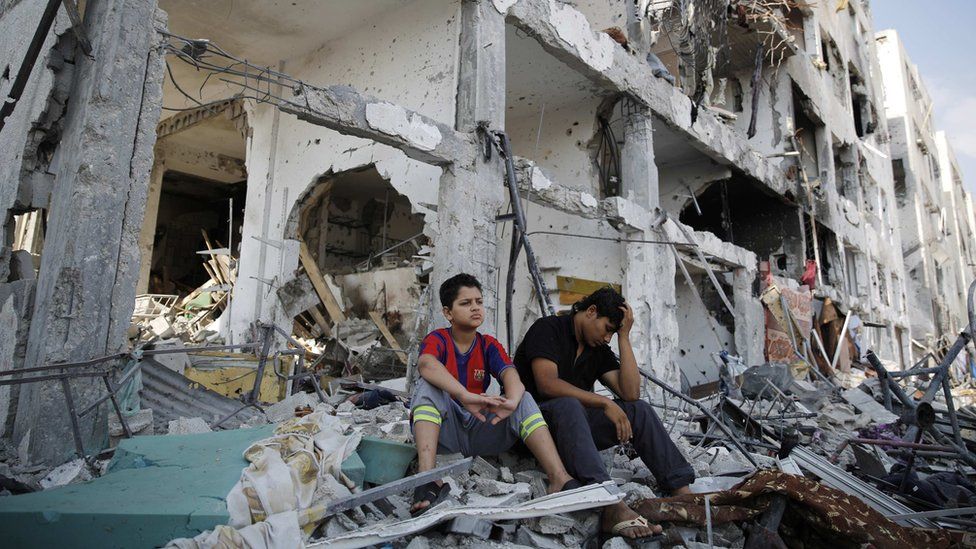 Palestinians sit on the remains of their destroyed homes in Beit Hanoun, Gaza (5 August 2014) Palestinians sit on the remains of their destroyed homes in Beit Hanoun, Gaza (5 August 2014)