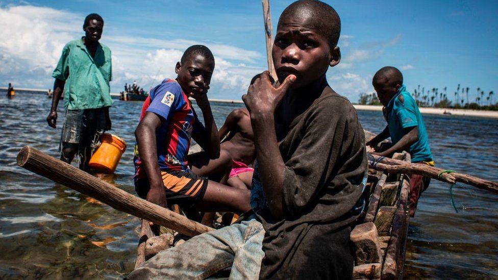 Young Mozambican fishermen return to the shore after several days of fishing in Palma, where large deposits of natural gas where found offshore, on February 16, 2017