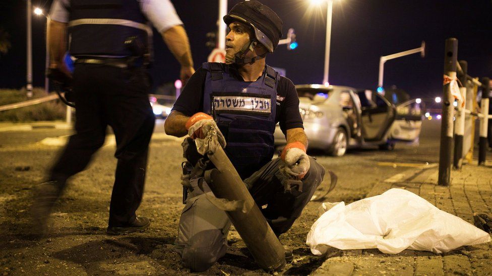 An Israeli police office removes the remains of a rocket fired from Gaza at Gan Yavne, Israel (22 August 2014) An Israeli police office removes the remains of a rocket fired from Gaza at Gan Yavne, Israel (22 August 2014)