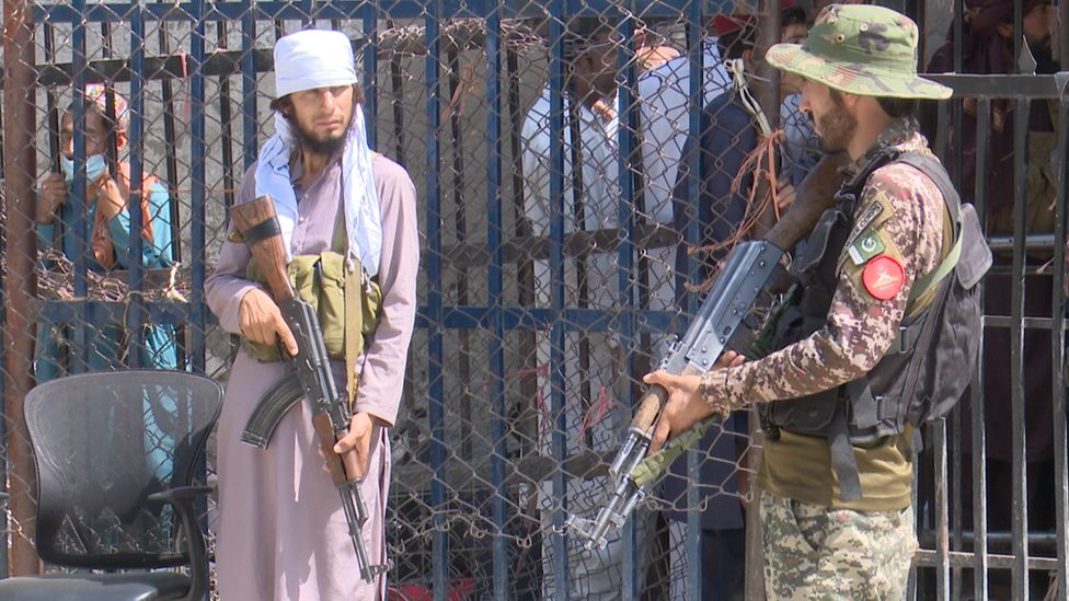 An armed Taliban fighter (left) and an armed Pakistani soldier at the Torkham crossing on the Pakistani-Afghan border An armed Taliban fighter (left) and an armed Pakistani soldier at the Torkham crossing on the Pakistani-Afghan border
