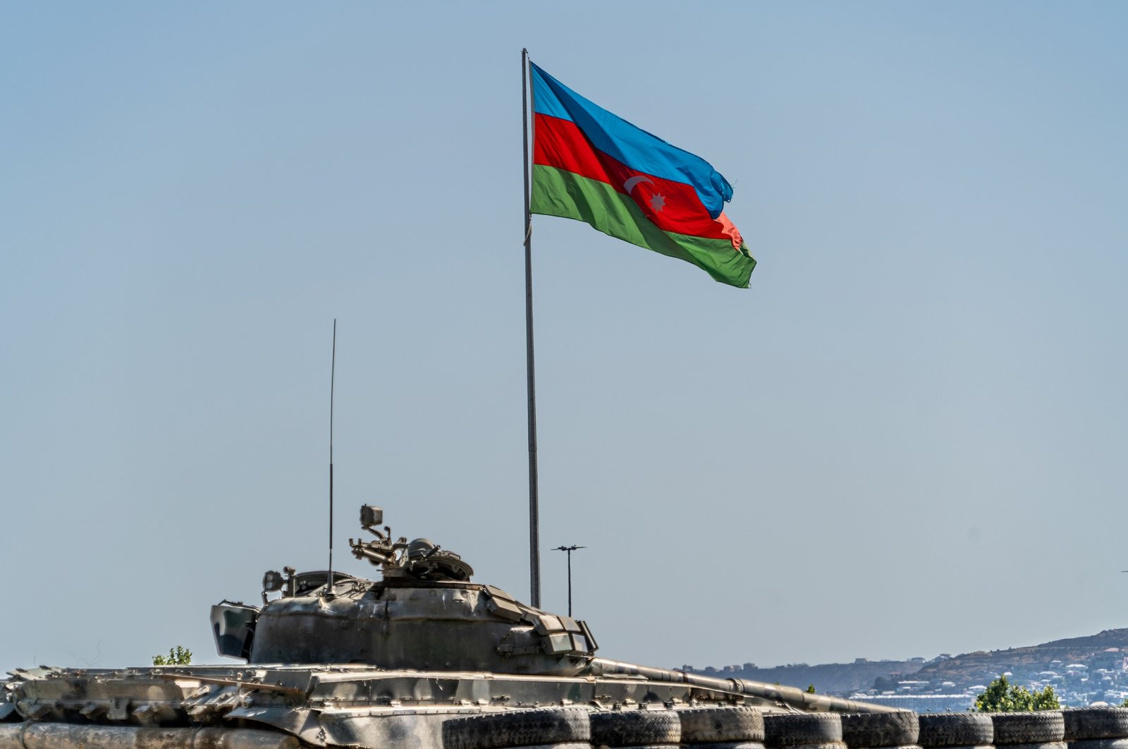 Azerbaijan flag flying above a captured Armenian tank in Trophy Park, Baku, Azerbaijan, June 16, 2021 (Getty Images)