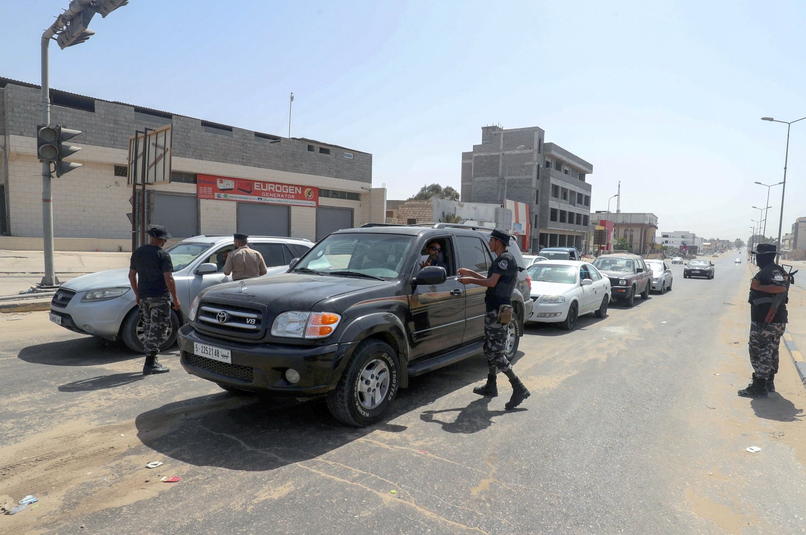 Libyan security officers run a checkpoint to verify the implementation of a total curfew the authorities announced a day earlier to mitigate the spread of the COVID-19 pandemic, in the capital Tripoli, Libya, Aug. 7, 2021. (AFP Photo)
