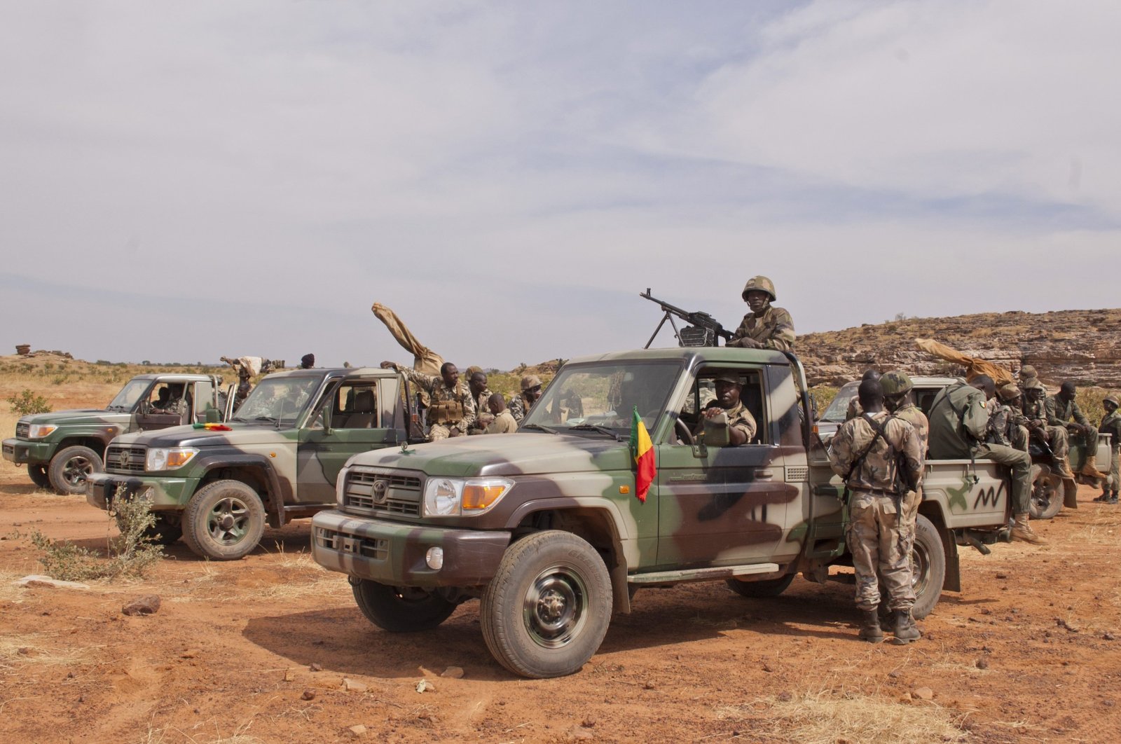 Soldiers from a Malian army special unit stand atop pick-ups mounted with machine guns, following a training exercise in the Barbe military zone, in Mopti, Mali, Nov. 24, 2012. (AP Photo)