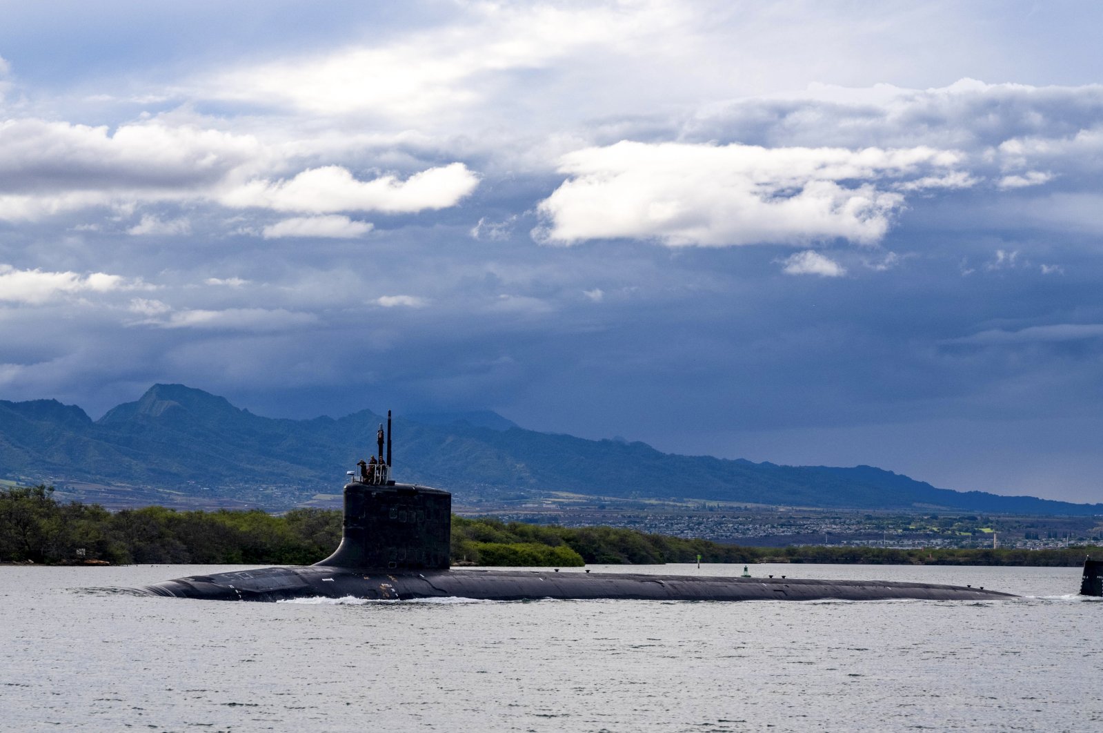 In this photo provided by U.S. Navy, the Virginia-class fast-attack submarine USS Missouri (SSN 780) departs Joint Base Pearl Harbor-Hickam for a scheduled deployment in the 7th Fleet area of responsibility, Sept. 1, 2021. (AP Photo)