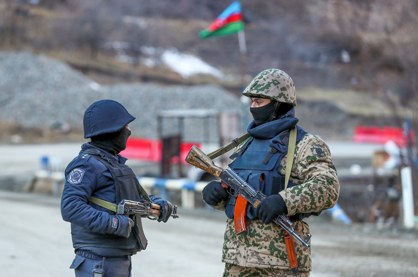 An Azeri soldier and police officer talk as they stand guard at the Kalbajar district, Azerbaijan, Dec. 21, 2020. (Reuters File Photo)