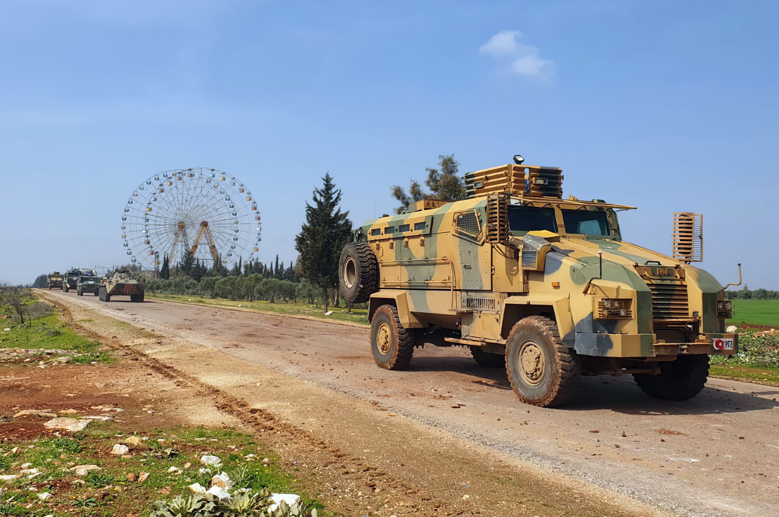 In this photo provided by the Turkish Defense Ministry, Turkish and Russian troops patrol on the M4 highway, which runs east-west through Idlib province, Syria, March 15, 2020. (Turkish Defense Ministry via AP)