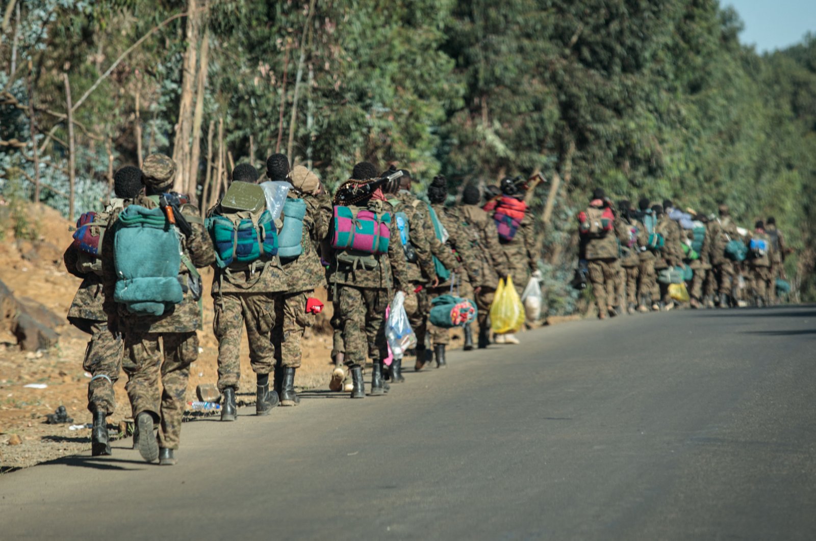 Soldiers of the Ethiopian National Defense Force (ENDF) walk along the road toward the frontline in Gashena, Ethiopia, Dec. 6, 2021. (AFP Photo)