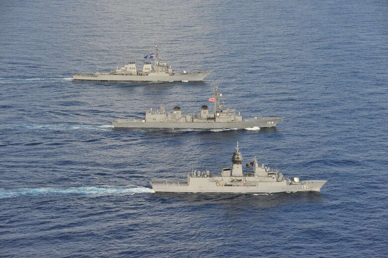 SOUTH CHINA SEA (Oct. 20, 2020) - The Arleigh Burke-class guided-missile destroyer USS John S. McCain (DDG 56) (rear), Japanese Maritime Self-Defense Force (JMSDF) ship JS Kirisame (DD 104) (middle), and Royal Australian Navy ship HMAS Arunta (FFH 151) (front) sail together in the South China Sea during multinational exercises. These exercises marked the fifth time of 2020 that Australia, Japan, and the U.S. have conducted operations together in the 7th Fleet area of operations.
