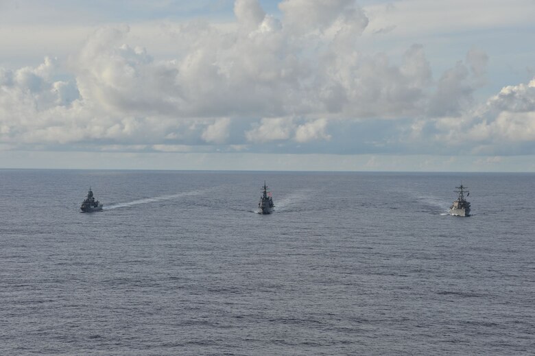 SOUTH CHINA SEA (Oct. 20, 2020) - The Arleigh Burke-class guided-missile destroyer USS John S. McCain (DDG 56) (right), Japanese Maritime Self-Defense Force (JMSDF) ship JS Kirisame (DD 104) (middle), and Royal Australian Navy ship HMAS Arunta (FFH 151) (left) sail together in the South China Sea during multinational exercises. These exercises marked the fifth time of 2020 that Australia, Japan, and the U.S. have conducted operations together in the 7th Fleet area of operations.