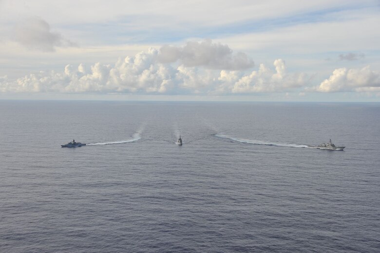 SOUTH CHINA SEA (Oct. 20, 2020) - The Arleigh Burke-class guided-missile destroyer USS John S. McCain (DDG 56) (right), Japanese Maritime Self-Defense Force (JMSDF) ship JS Kirisame (DD 104) (middle), and Royal Australian Navy ship HMAS Arunta (FFH 151) (left) sail together in the South China Sea during multinational exercises. These exercises marked the fifth time of 2020 that Australia, Japan, and the U.S. have conducted operations together in the 7th Fleet area of operations