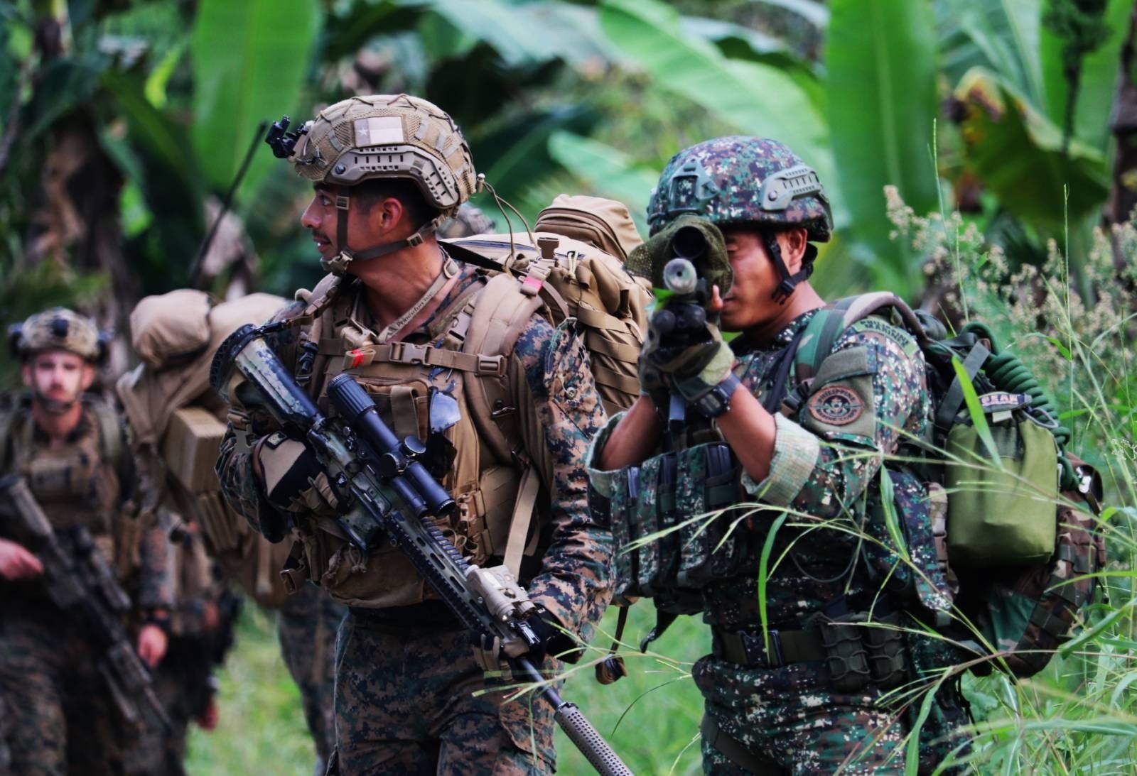 A handout photo made available by Philippine Marines Corps - Public Affairs Office (PMC-PAO) shows US and Filipino Marines soldiers maneuvering during a jungle survival drill
