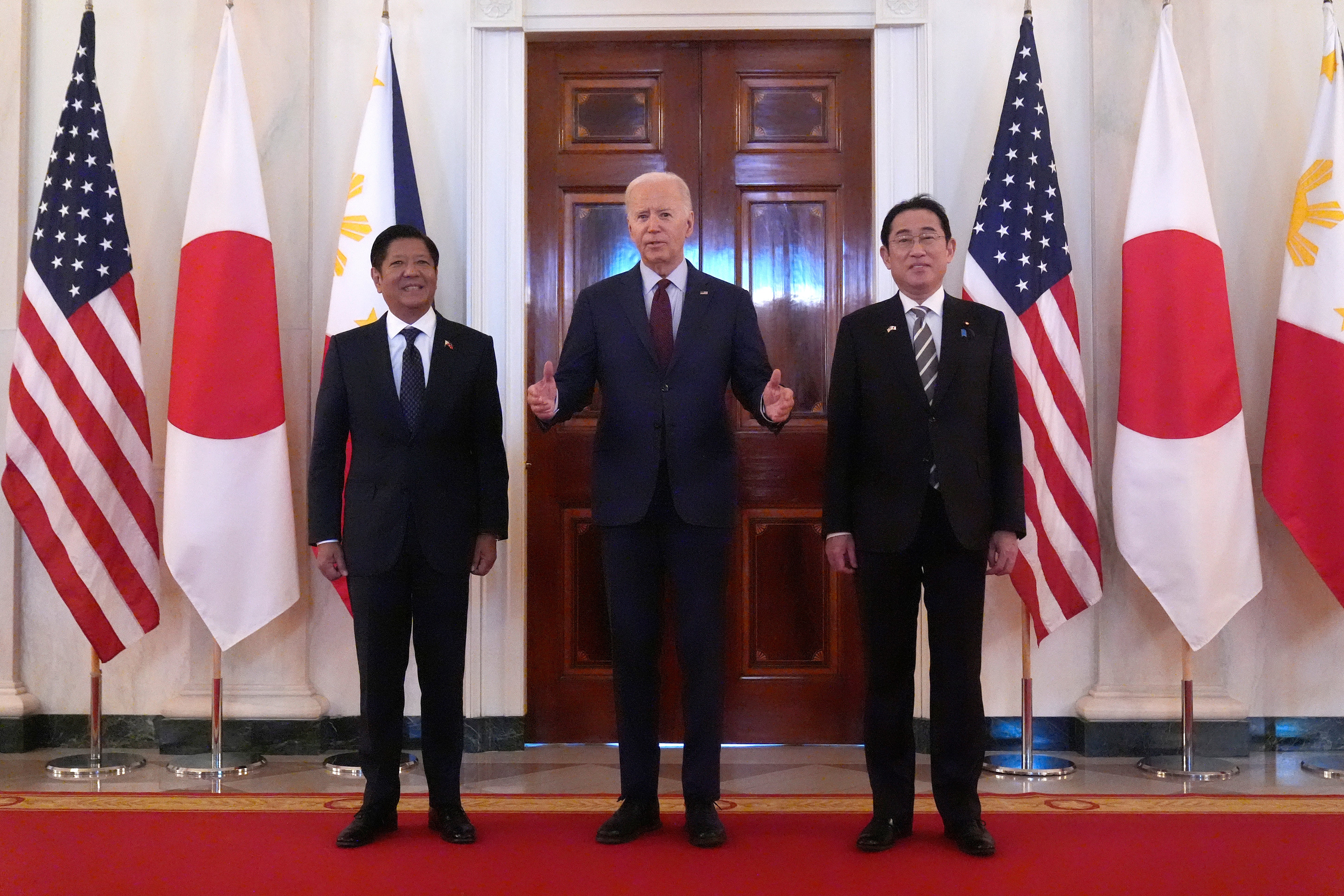 President Joe Biden, center, speaks alongside Philippine President Ferdinand Marcos Jr., left, and Japanese Prime Minister Fumio Kishida before a trilateral meeting