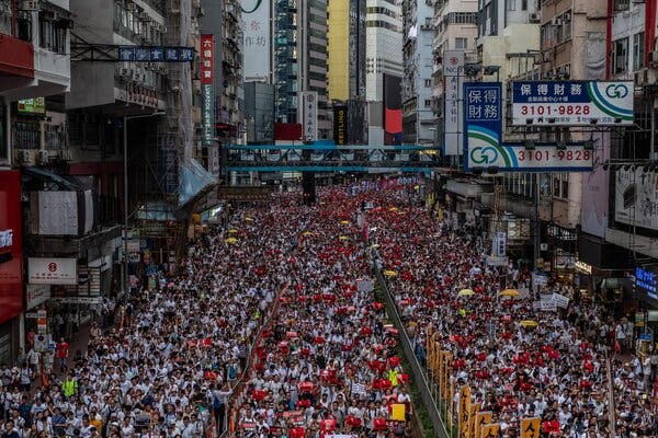 Thousands upon thousands of protesters crowd a wide Hong Kong street.